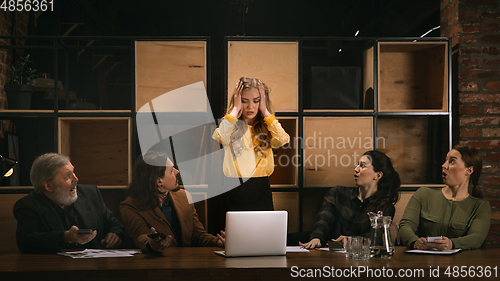 Image of Young colleagues working together in a office styled like classical artworks. Look busy, attented, cheerful, successful. Concept of business, office, finance.