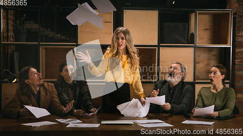 Image of Young colleagues working together in a office styled like classical artworks. Look busy, attented, cheerful, successful. Concept of business, office, finance.