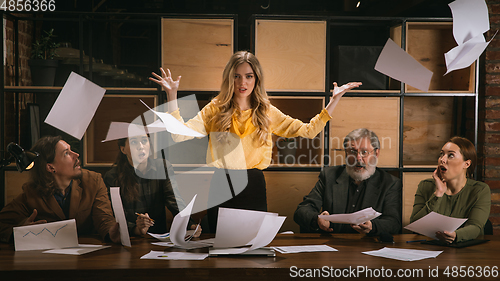 Image of Young colleagues working together in a office styled like classical artworks. Look busy, attented, cheerful, successful. Concept of business, office, finance.