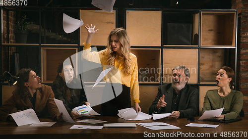 Image of Young colleagues working together in a office styled like classical artworks. Look busy, attented, cheerful, successful. Concept of business, office, finance.