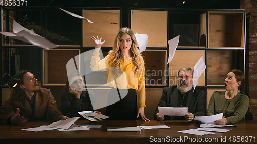 Image of Young colleagues working together in a office styled like classical artworks. Look busy, attented, cheerful, successful. Concept of business, office, finance.