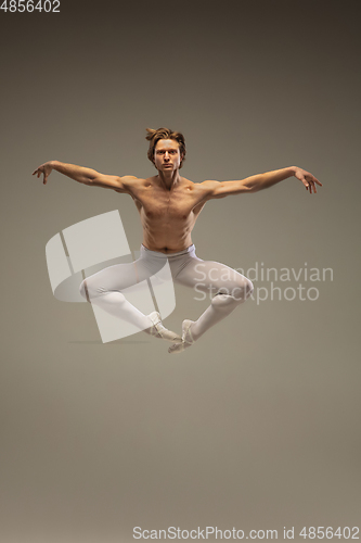 Image of Young and graceful ballet dancer isolated on studio background. Art, motion, action, flexibility, inspiration concept.
