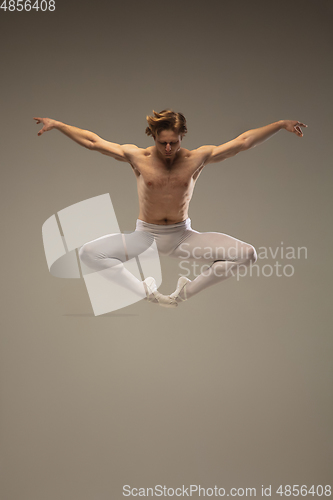 Image of Young and graceful ballet dancer isolated on studio background. Art, motion, action, flexibility, inspiration concept.