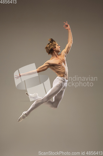 Image of Young and graceful ballet dancer isolated on studio background. Art, motion, action, flexibility, inspiration concept.