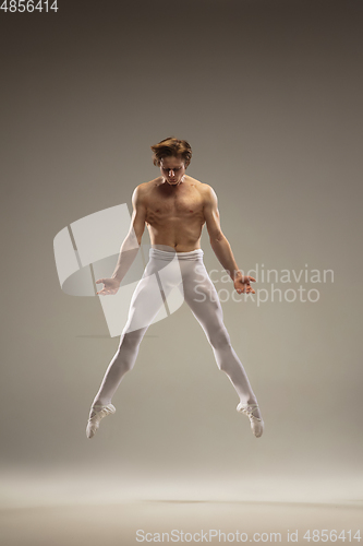 Image of Young and graceful ballet dancer isolated on studio background. Art, motion, action, flexibility, inspiration concept.