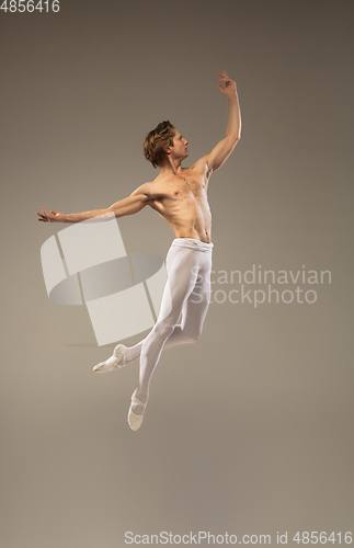 Image of Young and graceful ballet dancer isolated on studio background. Art, motion, action, flexibility, inspiration concept.