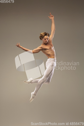 Image of Young and graceful ballet dancer isolated on studio background. Art, motion, action, flexibility, inspiration concept.