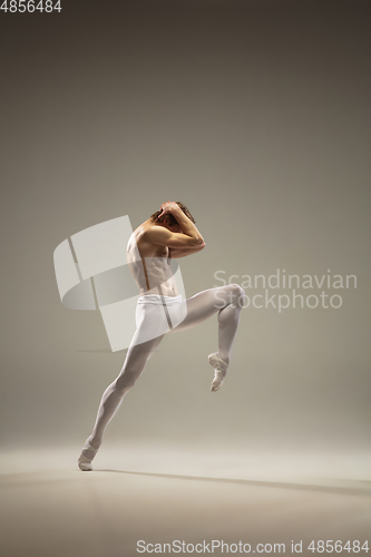 Image of Young and graceful ballet dancer isolated on studio background. Art, motion, action, flexibility, inspiration concept.