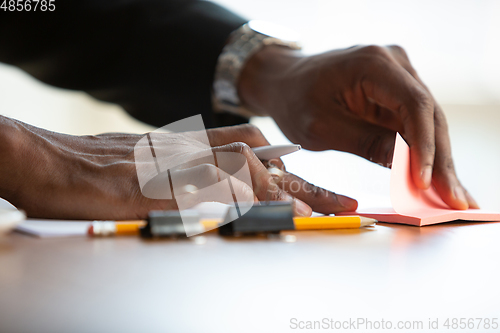 Image of African-american entrepreneur, businessman working concentrated in office