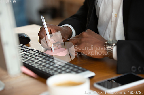 Image of African-american entrepreneur, businessman working concentrated in office