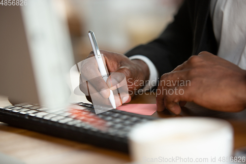 Image of African-american entrepreneur, businessman working concentrated in office