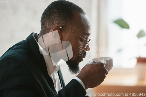 Image of African-american entrepreneur, businessman working concentrated in office