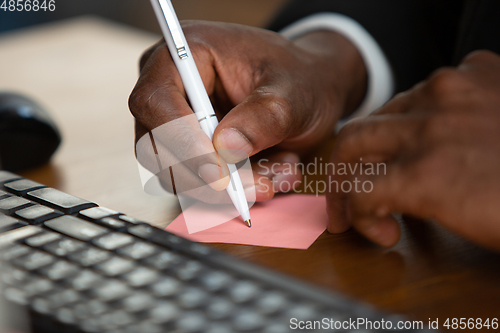 Image of African-american entrepreneur, businessman working concentrated in office