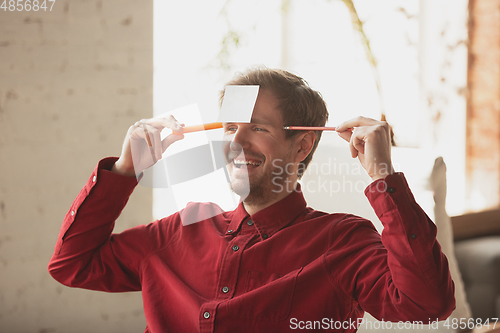 Image of Caucasian entrepreneur, businessman, manager trying to work, looks funny, lazy and spending time