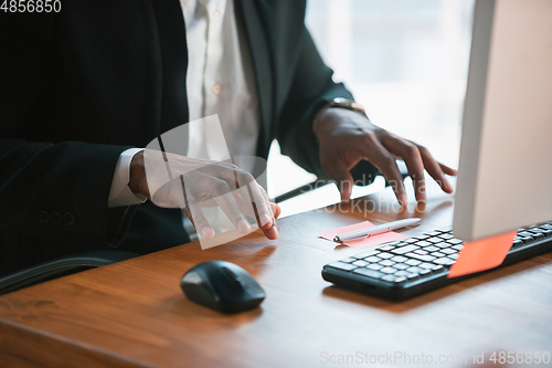 Image of African-american entrepreneur, businessman working concentrated in office