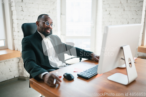 Image of African-american entrepreneur, businessman working concentrated in office