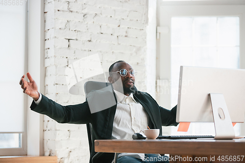 Image of African-american entrepreneur, businessman working concentrated in office