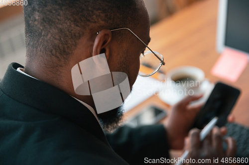 Image of African-american entrepreneur, businessman working concentrated in office