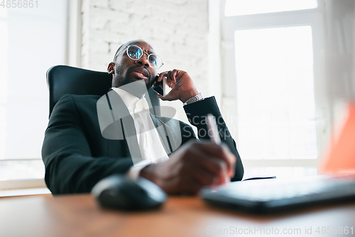 Image of African-american entrepreneur, businessman working concentrated in office
