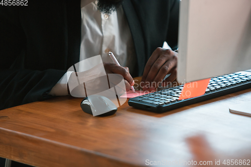 Image of African-american entrepreneur, businessman working concentrated in office