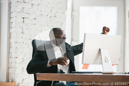 Image of African-american entrepreneur, businessman working concentrated in office