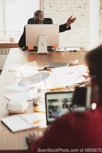 Image of Caucasian entrepreneur, businessman, manager trying to work, looks funny, lazy and spending time