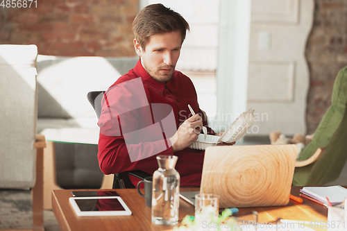 Image of Caucasian entrepreneur, businessman, manager trying to work, looks funny, lazy and spending time