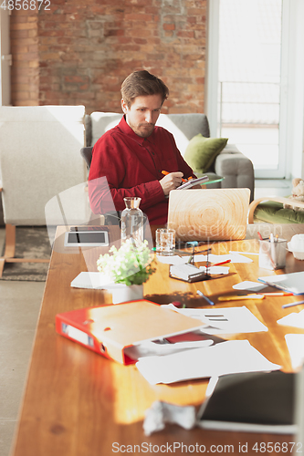 Image of Caucasian entrepreneur, businessman, manager trying to work, looks funny, lazy and spending time