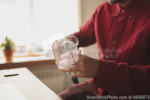 Image of Caucasian entrepreneur, businessman, manager trying to work, looks funny, lazy and spending time