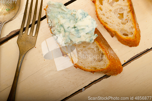 Image of fresh blue cheese spread ove french baguette