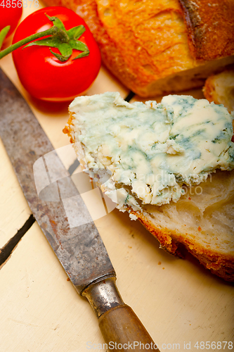 Image of fresh blue cheese spread ove french baguette