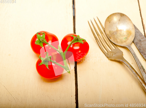 Image of ripe cherry tomatoes over white wood