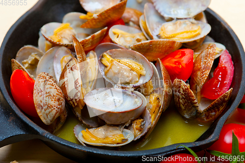 Image of fresh clams on an iron skillet
