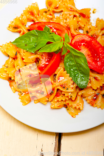 Image of Italian pasta farfalle butterfly bow-tie and tomato sauce