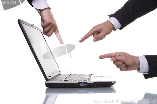 Image of Three hands pointing to a laptop