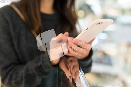 Image of Woman use of smart phone in shopping mall