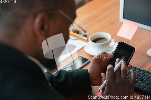 Image of African-american entrepreneur, businessman working concentrated in office