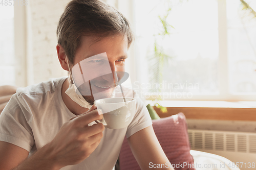 Image of Young man studying at home during online courses for financist, economist, managers