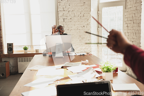 Image of Caucasian entrepreneur, businessman, manager trying to work, looks funny, lazy and spending time