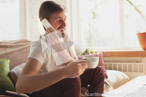 Image of Young man studying at home during online courses for marketer, architect, translator