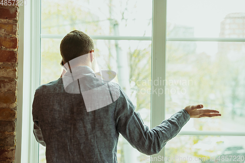 Image of Man working from home during coronavirus or COVID-19 quarantine, remote office concept