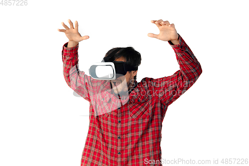 Image of Man emotional playing, using virtual reality headset isolated on white studio background