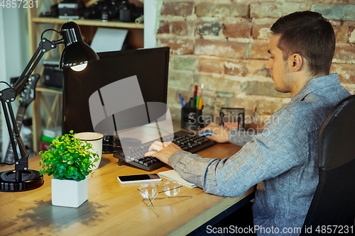 Image of Man working from home during coronavirus or COVID-19 quarantine, remote office concept