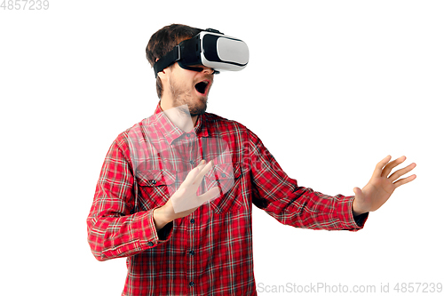 Image of Man emotional playing, using virtual reality headset isolated on white studio background