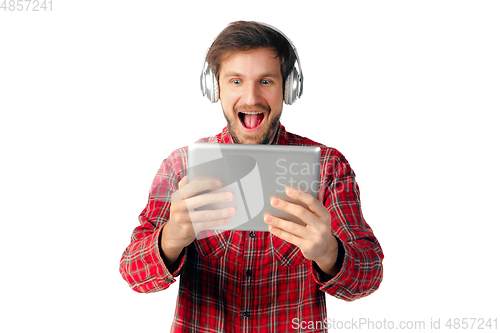 Image of Man using tablet and headphones isolated on white studio background