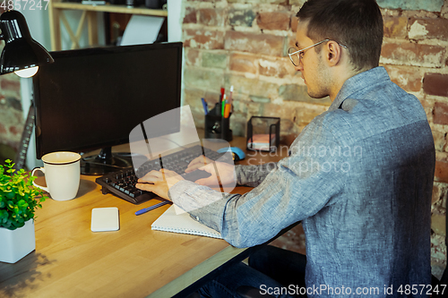 Image of Man working from home during coronavirus or COVID-19 quarantine, remote office concept