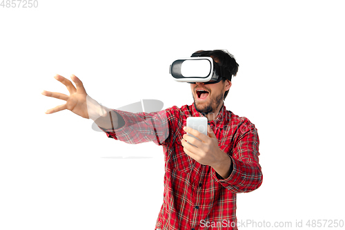 Image of Man emotional playing, using virtual reality headset isolated on white studio background