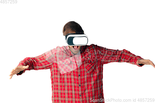 Image of Man emotional playing, using virtual reality headset isolated on white studio background