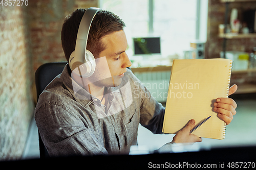 Image of Man working from home during coronavirus or COVID-19 quarantine, remote office concept