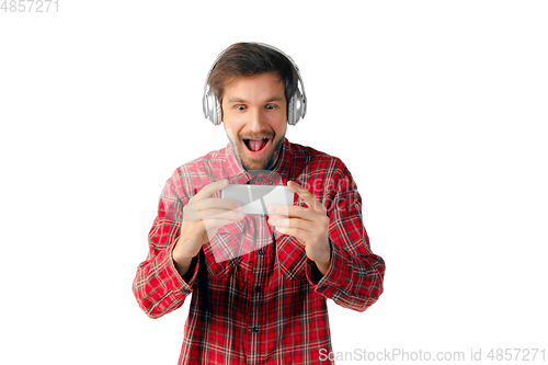 Image of Emotional man using smartphone isolated on white studio background